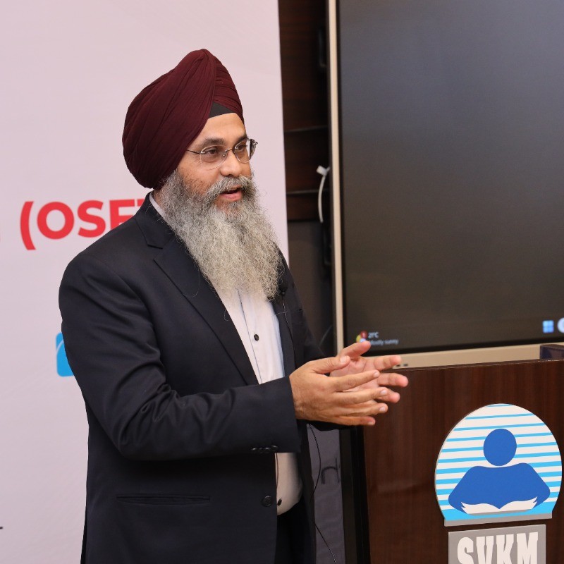 Dr. Maninder Singh speaking at a professional forum